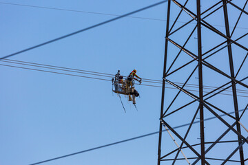 Line workers installing spacer dampers on high voltage power conductors.  Several scenes shot at each location to capture this detailed task.