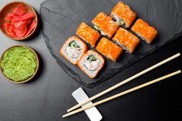 Sushi CALIFORNIA rolls with wasabi and ginger on a Board made of stone. Sushi food photo for menu.The view from the top