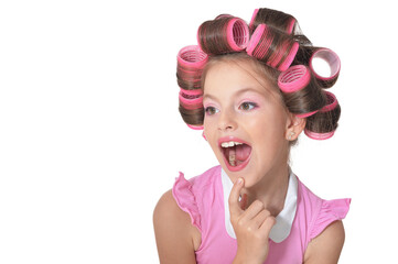 Portrait of little pretty girl with hair curlers posing