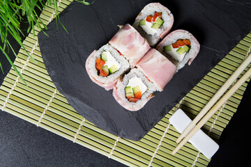 Sushi.  Texas Sushi rolls  on the dark background. Sushi food photo for menu. Sushi with ham