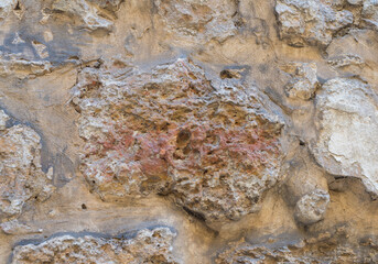 The ruins of an ancient wall with rough stones.