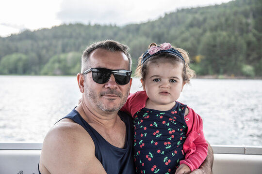 
father and daughter during boat trip on the lake in Sila National Park, Calabria, Italy