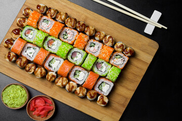 Sushi Philadelphia rolls, California, Miami rolls and bake the classic rolls on Board made of bamboo. Sushi food photo for menu. Combo set of rolls Sushi