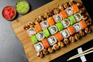 Sushi Philadelphia rolls, California, Miami rolls and bake the classic rolls on Board made of bamboo. Sushi food photo for menu. Combo set of rolls Sushi