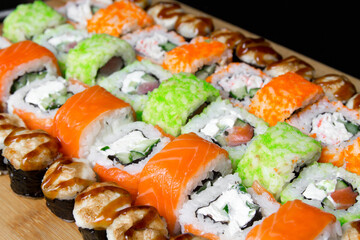 Sushi Philadelphia rolls, California, Miami rolls and bake the classic rolls on Board made of bamboo. Sushi food photo for menu. Combo set of rolls Sushi