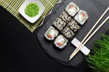 Sushi VENICE rolls with sesame and salmon with wasabi  on a Board made of stone. Sushi food photo for menu.The view from the top