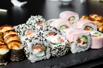 Sushi. Venice rolls, Texas rolls and bake rolls on the dark background. Sushi food photo for menu. Combo set of rolls Sushi
