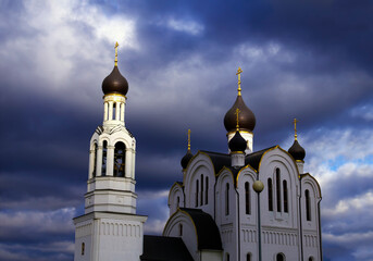 Beautiful scenic view - Russian Orthodox Church of St. Joseph Volotskiy at the background of dramatic stormy sky with dark clouds in Razvilka settlement, Moscow region, Russia