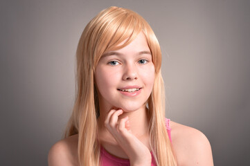 Portrait of beautiful girl posing in studio on background