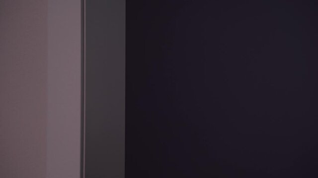 Scared young man in pink pajamas with flashlight on mobile phone in hand looks around the corner, sees something creepy, opens his eyes wide, covers mouth with palm and faints in dark room.