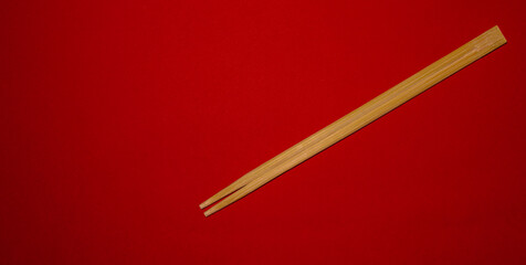 Chopsticks for oriental or asian food on a red background