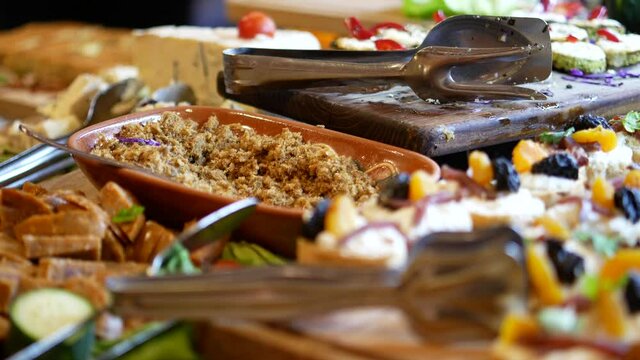 traditional serbian breakfast and apetizer, appetizer on the self-service table in the hotel, plates with cheese, cracklings, olives and canapes