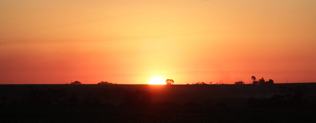  Sunset over the field at the golden hour.  Panoramic landscape.