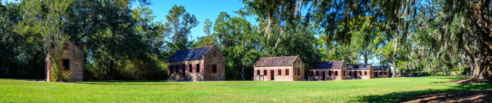Boone Hall Plantation, Mt Pleasant, South Carolina, USA - 10/2019:  Panoramic photo of slave quarters adjacent to oak lined road