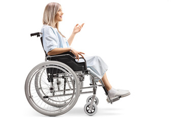 Hospitalized female patient in a wheelchair gesturing with her hand