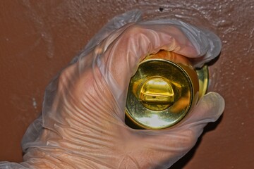 hand opening a door with gloves on