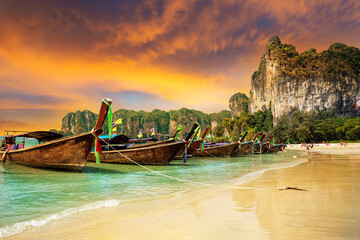 Traditional boats on Railay beach at sunset on the coast of Krabi region in Thailand © cristianbalate