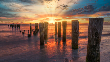 Old pier at sunset time. Travel and tourism concept.