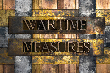 Wartime Measures text formed with real authentic typeset letters on vintage textured silver grunge copper and gold background