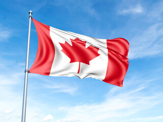Canada flag on a pole against a blue sky background.