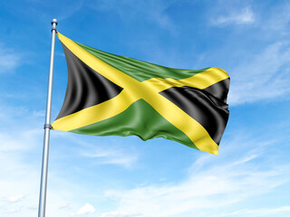 Jamaica flag on a pole against a blue sky background.