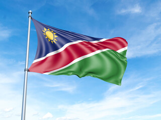 Fototapeta na wymiar Namibia flag on a pole against a blue sky background.