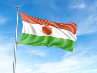 Niger flag on a pole against a blue sky background.