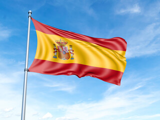 Spain flag on a pole against a blue sky background.