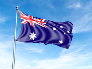 Australia flag on a pole against a blue sky background.