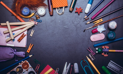 School supplies on black board background. Back to school concept with free copy space..
