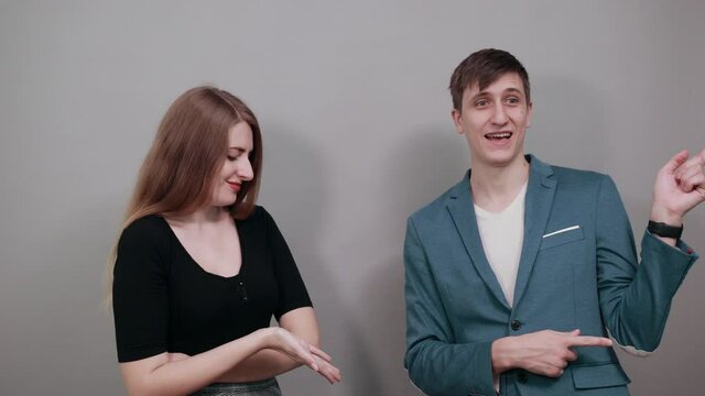 Hand pointer with forefinger pointing awry. Index finger to show direction. Means choosing, introducing too. Indicating towards. Young attractive couple boyfriend girlfriend two people