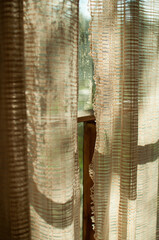 Dirty wooden window with knitted retro curtains the concept of poverty vartical align