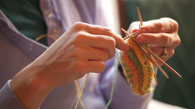 Woman knitting baby booties