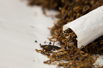 macro photo of hand rolled tobacco in its leaves. there is space in the photo for text.
