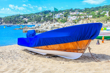 Fototapeta na wymiar Fishing boat covered with a blanket on the beach