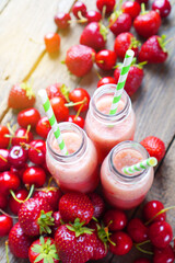 Summer smoothies background with red berries. Vertical.