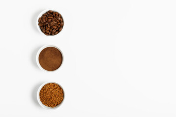 coffee beans, ground and black coffee or espresso in mugs on a white background. concept of different types and choices. coffee shop or store concept. flat lay, top view, minimalism, copy space..
