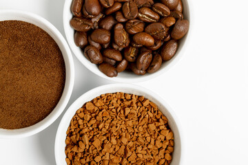 coffee beans, ground and black coffee or espresso in mugs on a white background. concept of different types and choices. coffee shop or store concept. flat lay, top view, closeup.