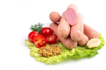 milk sausages, cherry tomatoes, dill, fried garlic, mustard sauce on lettuce leaves, close-up, isolated white background