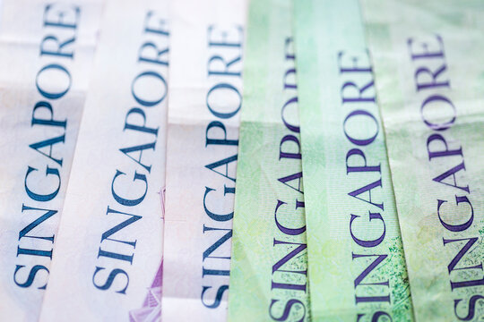 Obverse of overlapping Singapore Dollar SGD polymer banknotes of different denominations. Close-up.