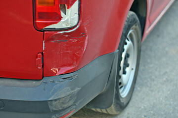 Fototapeta premium damage to the car after an accident. dent in the car and broken headlight. scratches on car paint. accident on the road.