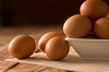Fresh farm eggs on a wooden rustic background