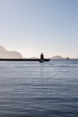 woman stands by beautiful mountains in norway