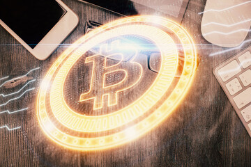 Double exposure of blockchain theme hologram over table with phone. Top view. Crypto technology concept.