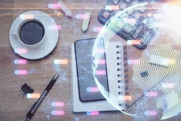 Double exposure of map hologram drawing over desktop. Top view. International connection concept.