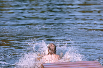 Girl jumped into the water from the bridge hot summer, around a lot of splashes