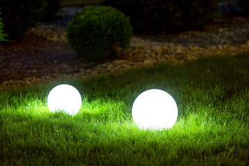 backyard 2 light garden with lantern electric lamp with sphere diffuser in green grass with thuja...