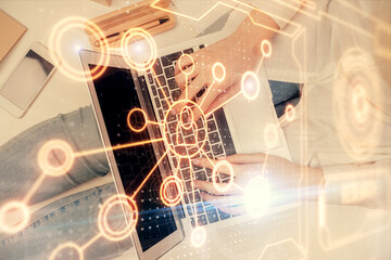 Double exposure of woman hands working on computer and social network theme hologram drawing. Top View. People connection concept.