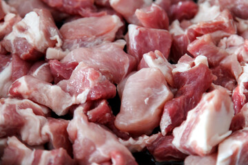 Raw cuts meat close-up, raw pork against background of cooking fat meat at home. Food is large on plate. Lots fat.Filling. Delicious frying of meat products. Cooking stew in rustic style, top View