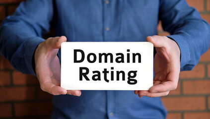 Domain rating - seo concept in the hands of a young man in a blue shirt